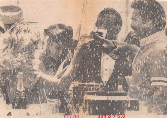 Original caption from Daily Breeze, June 25, 1980: "Burt Reynolds and Farrah Fawcett in Redondo Beach? That's right, they were filming some scenes from a no-hold-barred race from New York to Redondo Beach for a new movie, "Cannonball Run." The wrap-up was a wild champagne-squirting party that engulfed newsmen, photographers and a clutch of curious tourists. (Daily Breeze file)