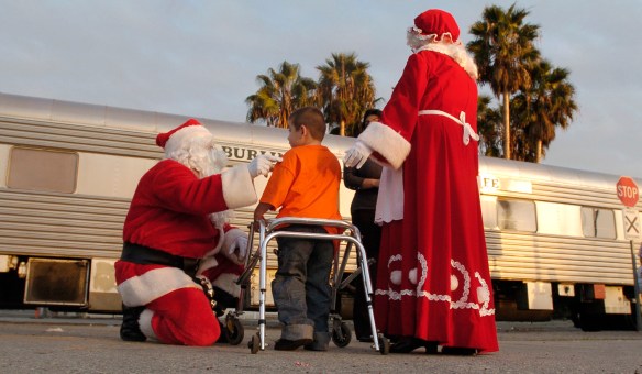 Brandon Velazquez, 6, says goodbye to Santa and Mrs. Claus after riding on the BNSF Santa Claus Express Holiday Train that rolled into Wilmington taking the young passengers through the Alameda Corridor Thursday. Children ate cookies, sang Christmas carols and received presents. Nov. 29, 2007 Daily Breeze file photo.