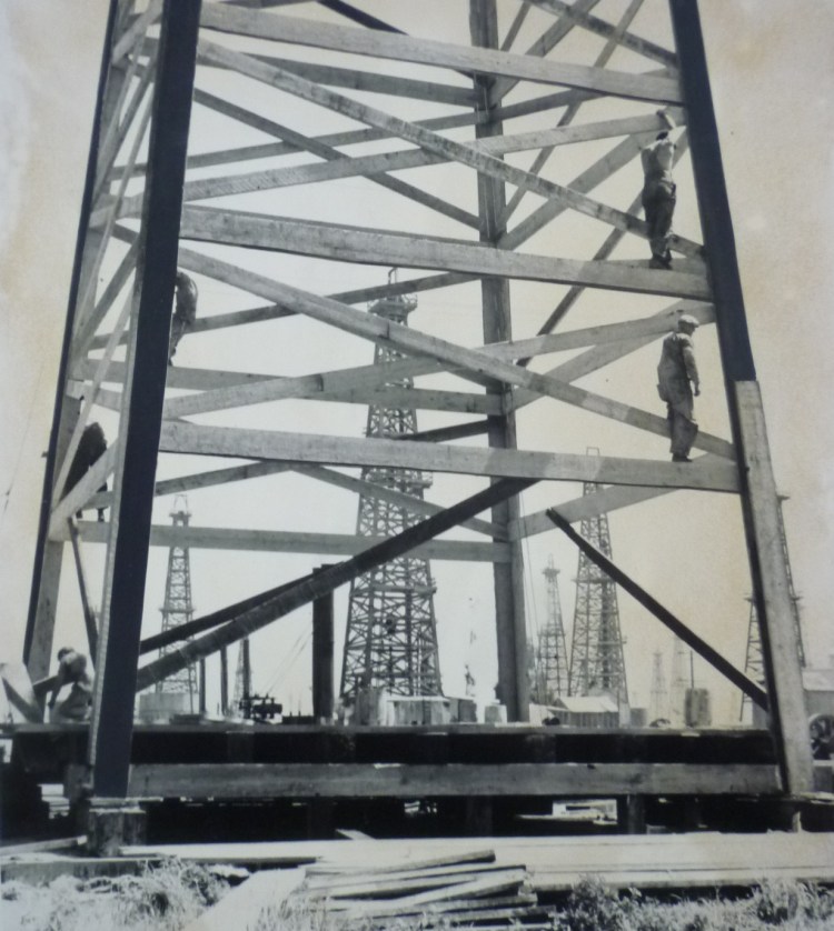 Workers on a wooden oil derrick in the Del Amo oil field in South Torrance in this circa 1938 photo. (Daily Breeze file photo)