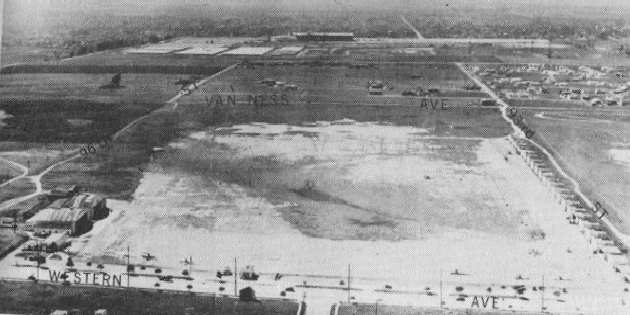 An aerial view looking west at Dycer Airport just east of Inglewood, with Hollywood Park in background. Two large hangars can be seen at lower left, with smaller hangars lining the right side. (Courtesy of Dan MacPherson/Abandoned & Forgotten Airports)