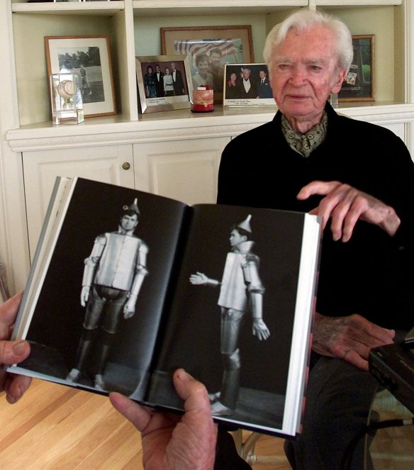 Actor Buddy Ebsen, 93, points to a book that shows him wearing the costume of the "Wizard of Oz" character the Tin Man, during an interview at his home in Palos Verdes Estates, Calif., May 24, 2001. (AP Photo/Damian Dovarganes)