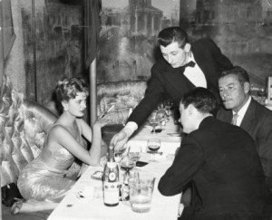 16-year-old Beverly Aadland, left, at the Lido Club in London, England on May 5, 1959, with actor Errol Flynn, far right.