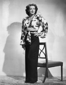 Actress Rosemary DeCamp models a patterned hostess blouse with an attached sash, with a pair of black gabardine slacks in a 1947 fashion shoot. This stylish outfit was designed by Joseph Zukin. (Photo by Fox Photos/Getty Images)