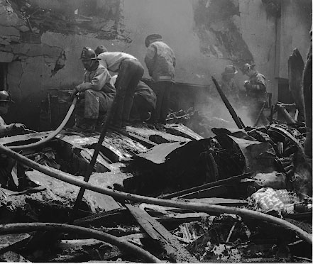 Firefighters knock down the blaze following the B-26 crash in El Segundo. The fire was put out less than an hour after the crash. Daily Breeze file photo.