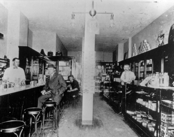 Harry H. Dolley, left, behind soda fountain, and his father, W.C. Dolley, with mustache at right, inside the Dolley Drug Co. in a circa 1922 undated photo. (Credit: Torrance Historical Society)