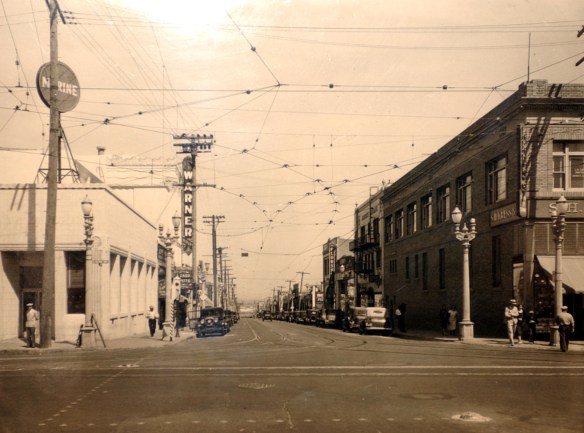 A view from Pacific Avenue looking down 6th, shows the Warner Grand Theater to the left and cable car lines spanning the street, in this undated photo from the 1930's. (Photo courtesy San Pedro Bay Historical Society)