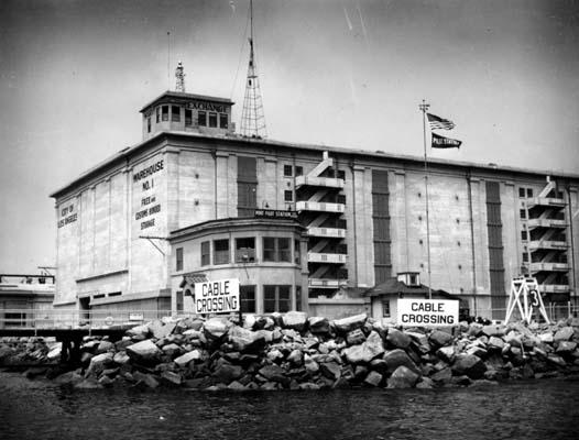 The Marine Exchange's original perch atop Warehouse No. 1 at the Port of Los Angeles can be seen at upper left of this undated photo. (Photo credit: Wikimapia)
