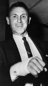 Leonard W. Gilman, associate deputy regional commissioner of the United States Border patrol in El Paso, Texas, displays the cast covered hand which he injured when he slugged a gunman on board an airliner on Thursday, August 3, 1961. The gunman, Leon Bearden, and his son, Cody, 17, had commandeered the plane in the air between phoenix and El Paso. Then they attempted to take it to Havana. (AP Photo)