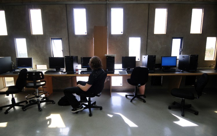 A student works in a computer lab lit by small rectangular windows in their building that was originally built for IBM in this October 2008 file photo. (Scott Varley / Staf Photographer)