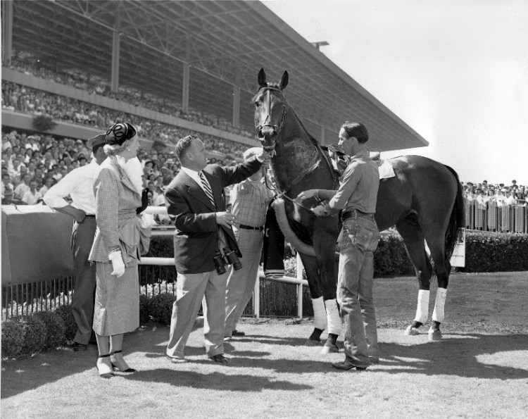 Citation is shown in the winner's circle after taking a bow at Hollywood Park in Inglewood, Ca., on July 21, 1951. Citation, the first race horse to win $1 million, was retired to stud on July 20. Standing with "Big Cy," from left, are, owner Lucille Park