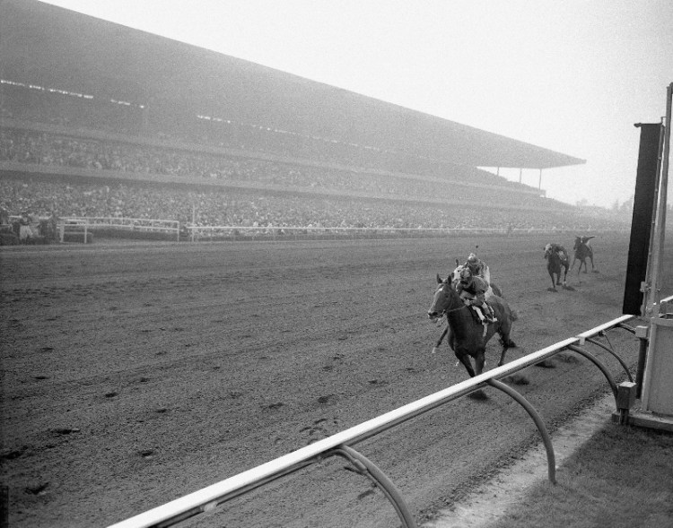 orses Named Swamps Action Thundering to a new world record for the mile in 1:33 1/5 at Hollywood Park in Inglewood, California June 9, 1956, Swaps (2, on rail) with Willie Shoemaker up, crosses the finish line to win the $50,000 added Argonaut handicap