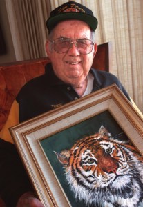 Bill "Tiger" Reese holds one of his prize possessions, a tiger portrait painted by one of his friends as a gift, in this 1999 file photo. (Daily Breeze staff photo by Robert Casillas)