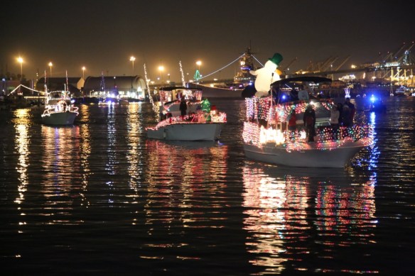 The line of boats passes through the harbor during the 2014 parade. 