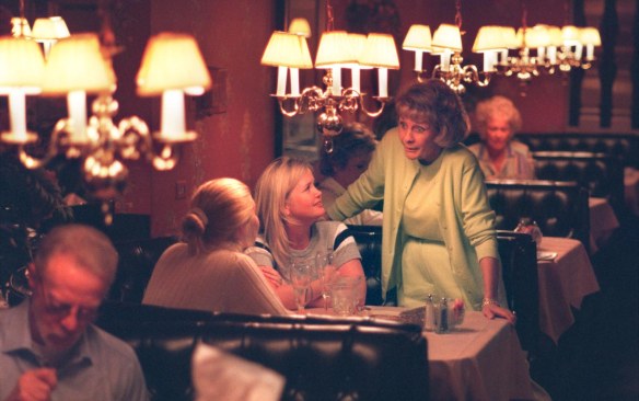 Sandy Del Conte (standing) reminisces with former hostess Heather Hill , center, during lunch at Del Conte's Restaurant on its closing day, Feb. 3, 1999. (Brad Graverson / Staff Photographer)