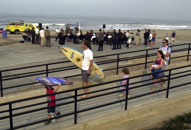 Beach goers walk on the new access ramps on Torrance Beach as the rededication ceremony goes on in the background for the $3.6 million renovation. Daily Breeze photo by Brad Graverson.