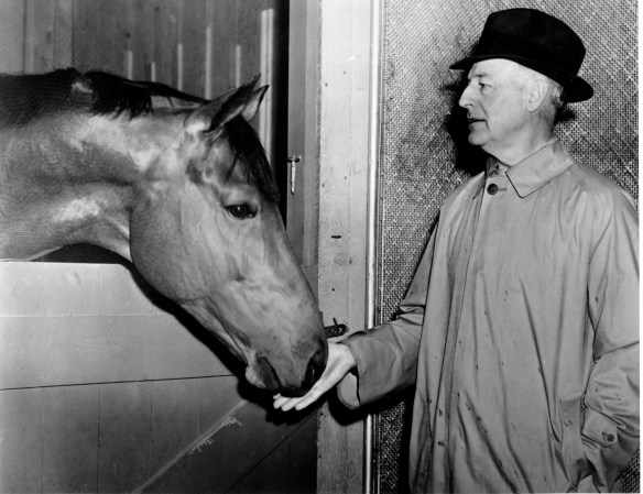 American racehorse Seabiscuit nibbles on the hand of owner Charles S. Howard at the Santa Anita stable at Arcadia, near Los Angeles, Ca., on Feb. 10, 1938. (AP Photo)