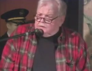 Bob Hare, Insomniac founder, reading poetry at a Hermosa Beach Historical Society event in 2008. (Video still from Hermosa Beach Historical Society video.)