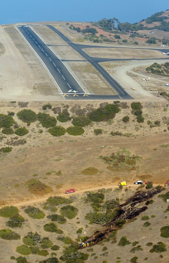 Fire crews tend to the wreckage of a private plane that crashed at the edge of the Catalina airport that killed three people in 2008. (Long Beach Press-Telegram staff file photo)