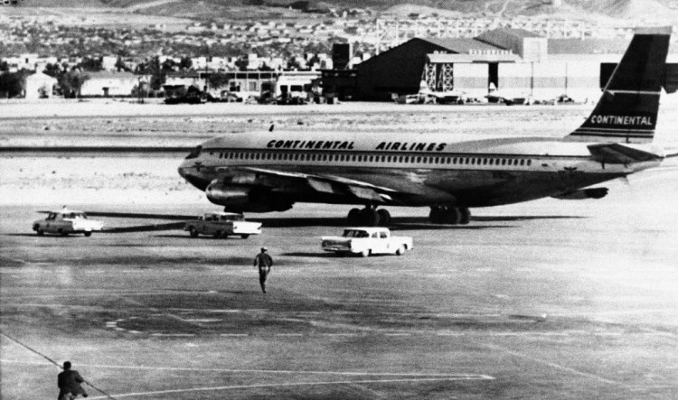Police cars race round in airliner as it attempted to take off in the control of two gunmen at El Paso, Texas on August 3, 1961, police officers opened fire on the undercarriage, bursting the types and halting the plane. After holding crew and passengers hostage for several hours, the hijackers surrendered. They said they wanted to take the plane to Havana. (AP Photo)