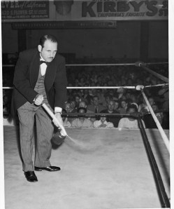 Jeffries Brown, Gorgeous George's valet, is seen here spraying a Hollywood ring before George appears, May 13, 1948. (AP Photo)