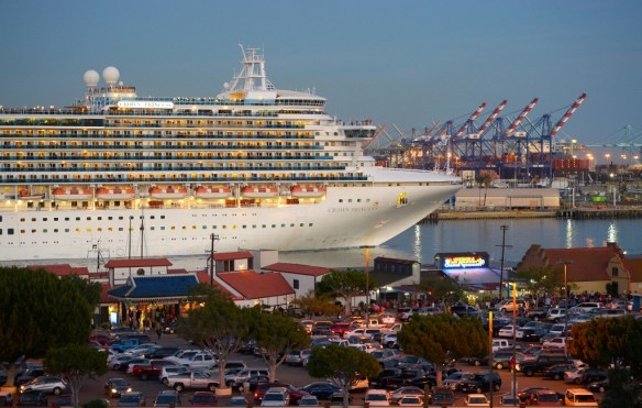 The Pacific Princess cruise ship Crown Princess slips out of the Port of Los Angeles and by a crowded Ports O’ Call in San Pedro, CA at dusk on Saturday, February 14, 2015. (Scott Varley / Staff Photographer)