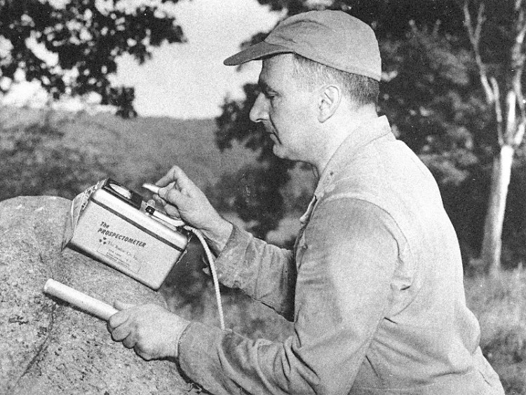 An unidentified workman demonstrates the new Geiger Counter, specifically designed for Uranium and Thorium prospecting, in this photograph from 1954. (AP Photo)