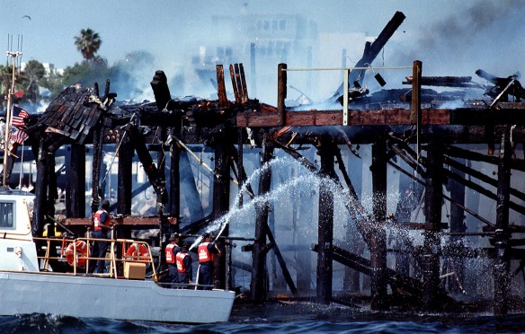 Firefighters hose down smoldering remains of northern section of Redondo Beach pier that was devastated by the May 27, 1988 fire. (Daily Breeze file photo)
