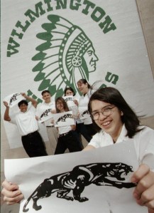 Students hold images of Wilmington Middle School's new "Jaguars" logo, with the old "Warriors" logo in the background. April 6, 1998. (Daily Breeze staff file photo)