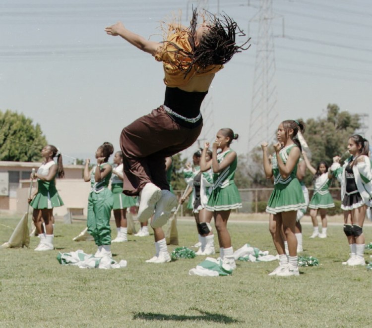 17-year-old Zack Fisher performs a flip while clad in his Mohican mascot outfit at the April 17, 1998 rally. (Daily Breeze staff file photo)