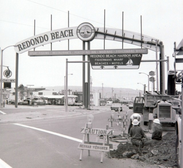 This June 1969 Daily Breeze file photo shows the original gateway sign at front right, and the then-new sign under construction at rear.