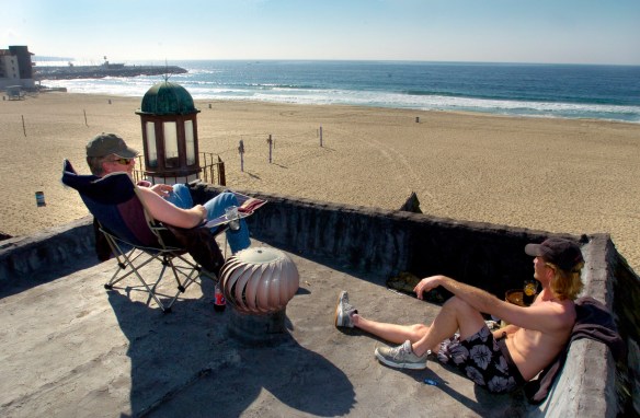 Brothers Gregory and Lucien Hall relax on the rooftop of the Hermosa Beach home at 100 The Strand. Lucien was living there at the time this photo was taken on Jan. 28, 2004. File photo. (Brad Graverson / Staff Photographer)