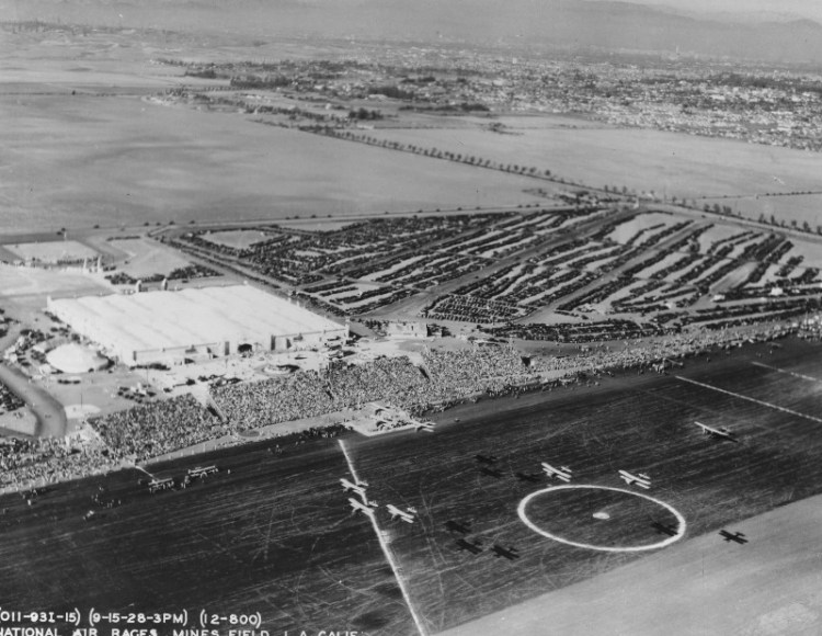 The 1928 National Air Races at Mines Field. Note the large crowd in the stands and the rows of parked cars behind and to the right.  (Photo credit: Los Angeles World Airports)